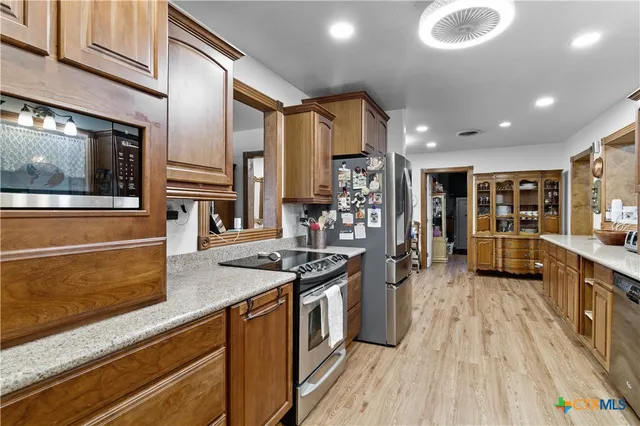 a kitchen with stainless steel appliances granite countertop a stove and a sink