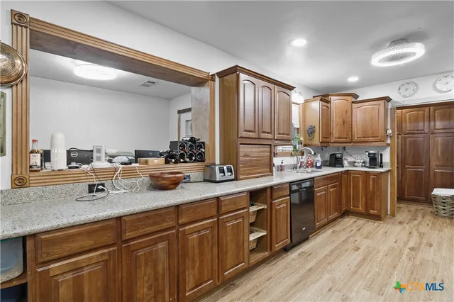 a kitchen with stainless steel appliances granite countertop a sink counter space and cabinets