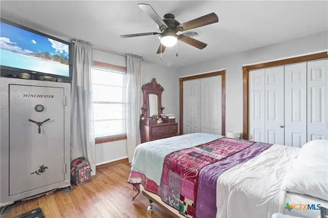 a bedroom with a large bed and a chandelier