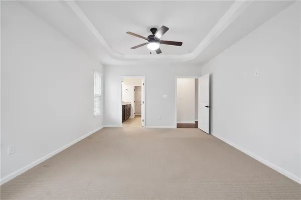 a view of a livingroom with a ceiling fan & window