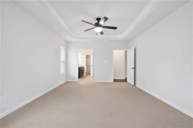 a view of a livingroom with a ceiling fan & window