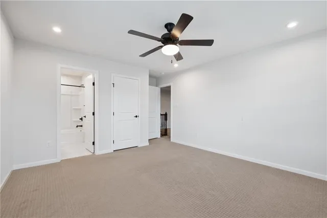 an empty room with closet and windows