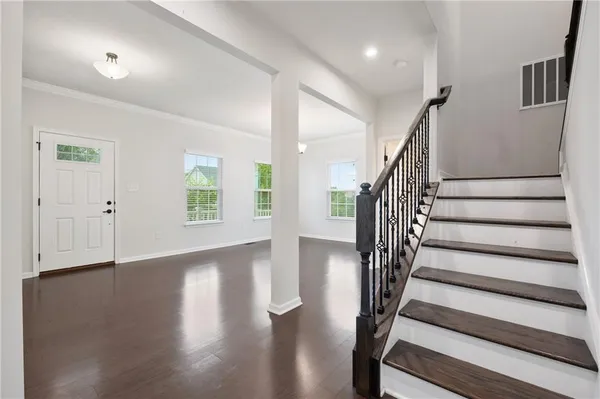 a view of entryway with wooden floor and stairs