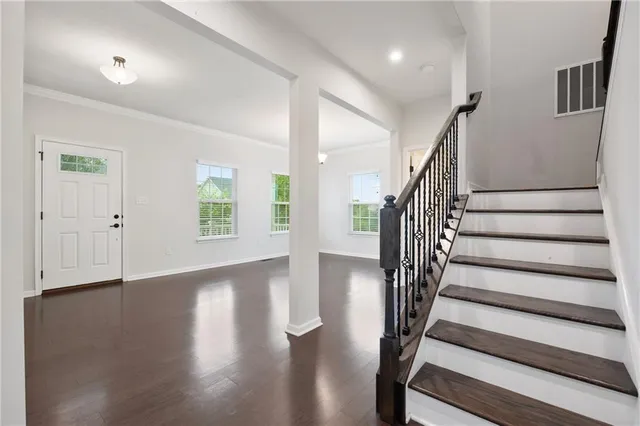 a view of entryway with wooden floor and stairs