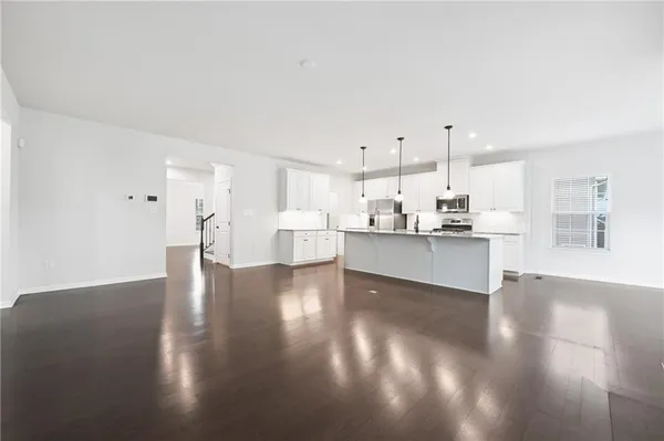 a view of kitchen with kitchen island and stainless steel appliances
