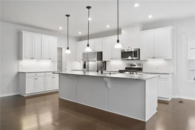 a large kitchen with stainless steel appliances lots of counter space sink and cabinets
