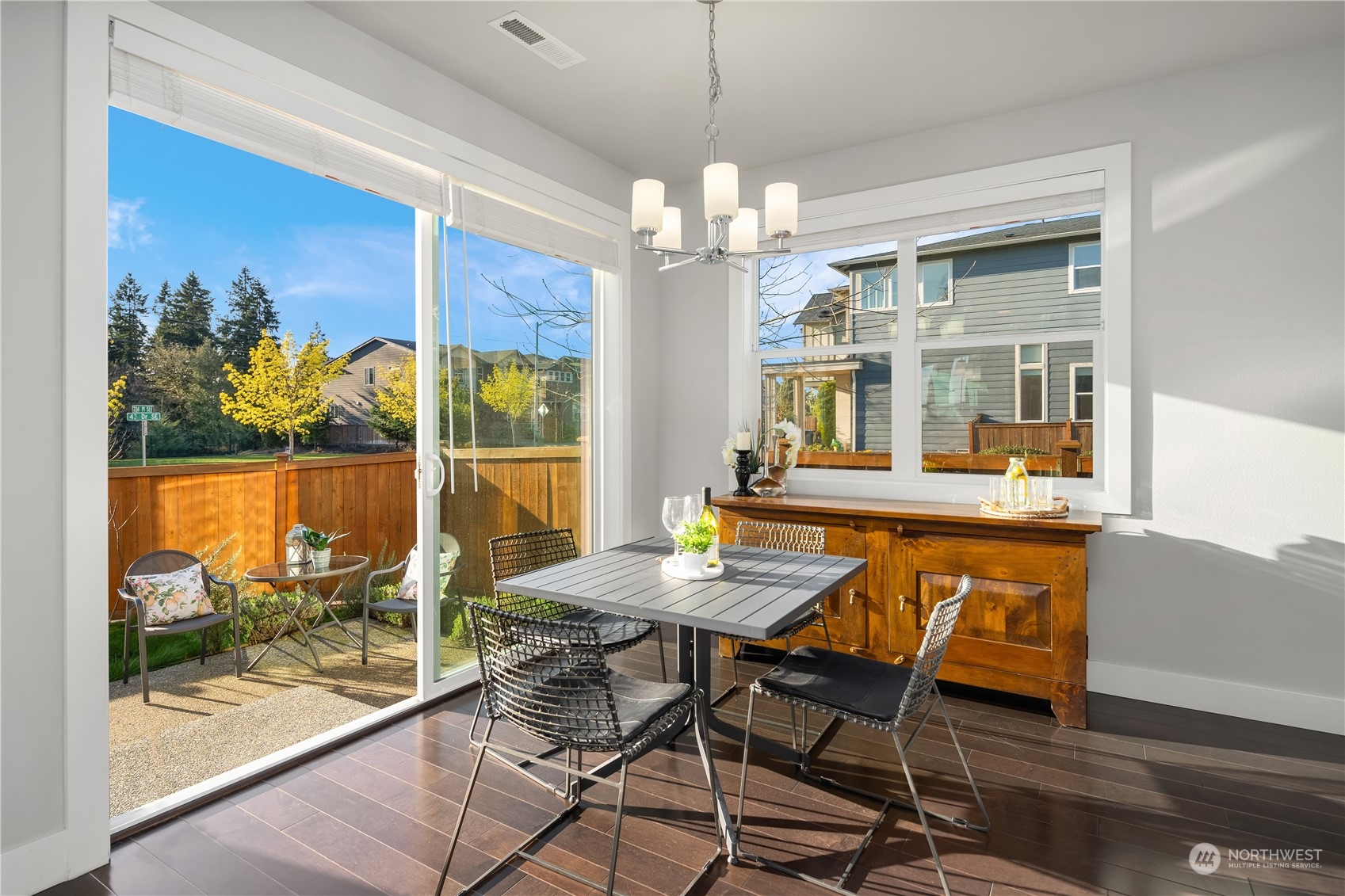 4312 224th Place Southeast Bothell, WA 98021 - Photo 14 of 40 a dining room with wooden floor a chandelier a wooden table and chairs