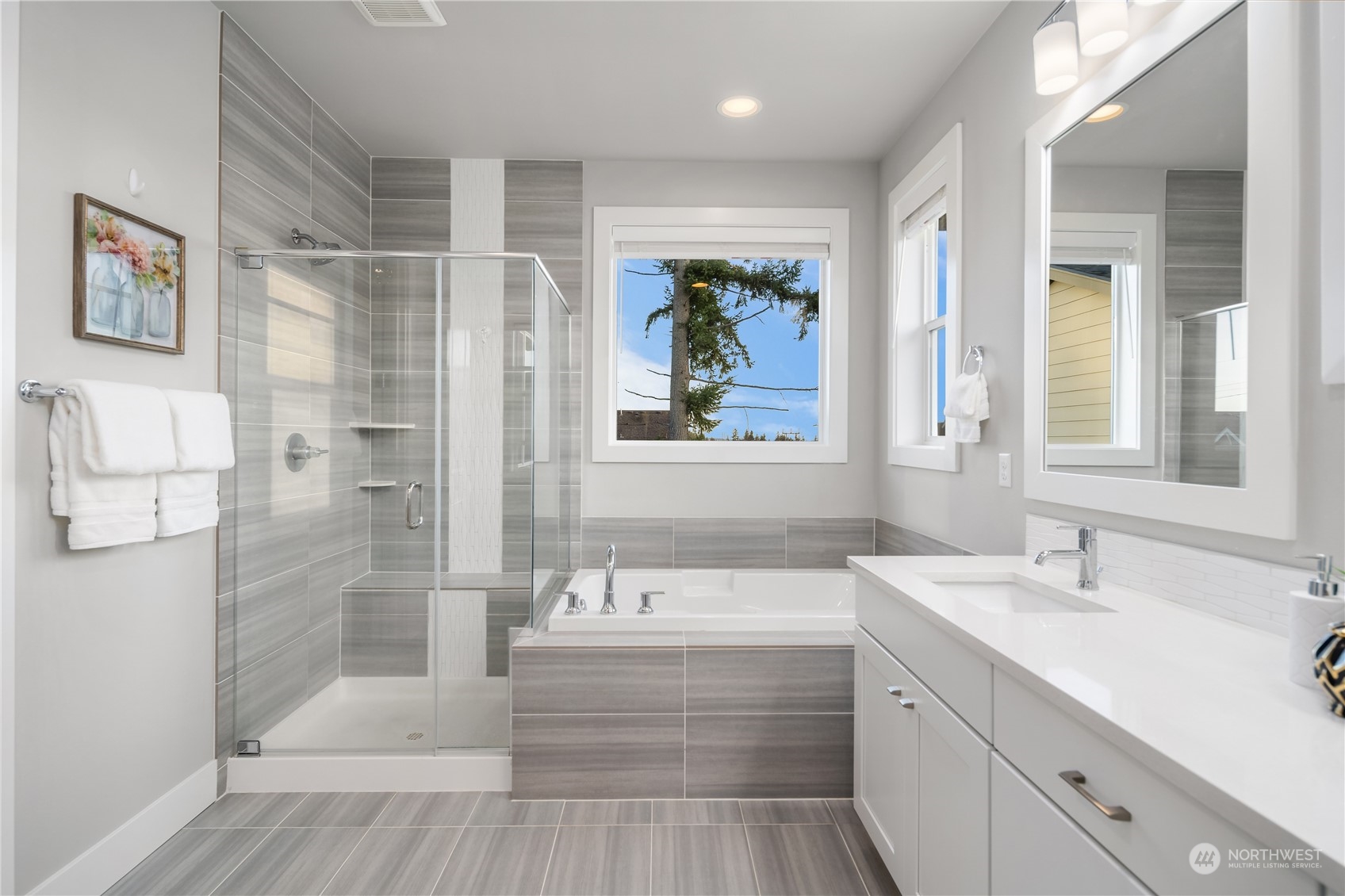 4312 224th Place Southeast Bothell, WA 98021 - Photo 21 of 40 a bathroom with a tub a sink and mirrors