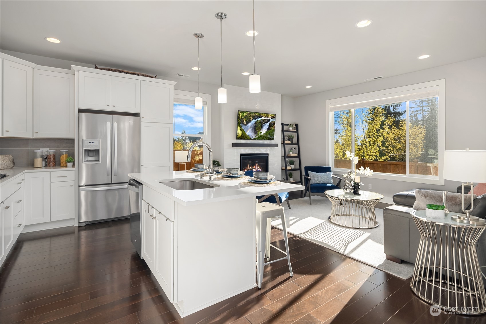 4312 224th Place Southeast Bothell, WA 98021 - Photo 5 of 40 a kitchen with a refrigerator a stove top oven a sink dishwasher and white cabinets with wooden floor