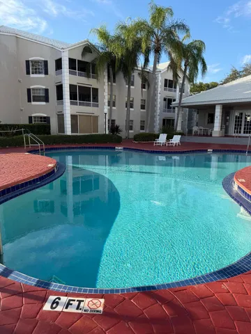 a swimming pool with outdoor seating and yard