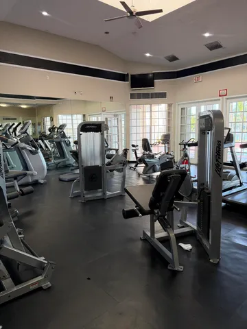 a room with gym equipment and a large window