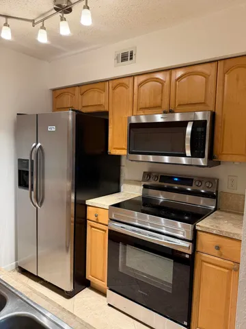 a kitchen with a stove and a microwave