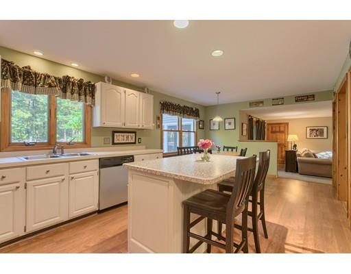 19 Justice Hill Road Sterling, MA 01564 - Photo 8 of 30 a kitchen with stainless steel appliances granite countertop a table chairs and a refrigerator