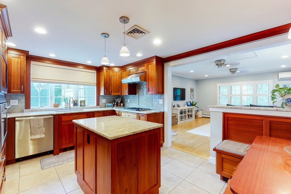 9 Mellen Street Needham, MA 02494 - Photo 13 of 42 a large kitchen with kitchen island a large counter space dining table and chairs