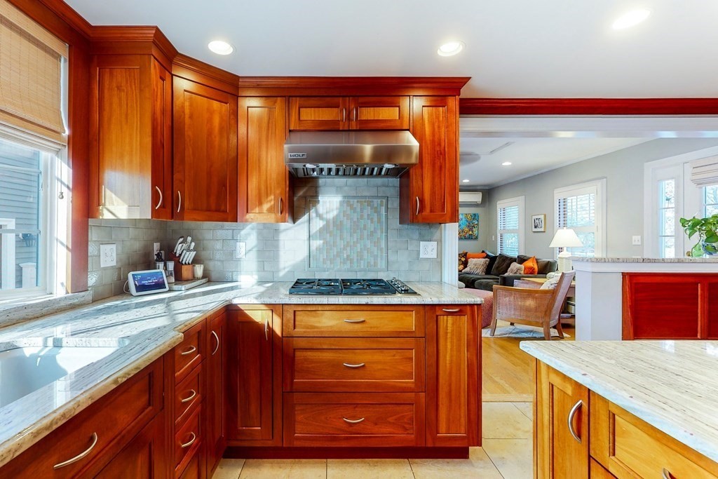 9 Mellen Street Needham, MA 02494 - Photo 15 of 42 a kitchen with stainless steel appliances granite countertop a stove a sink and a microwave