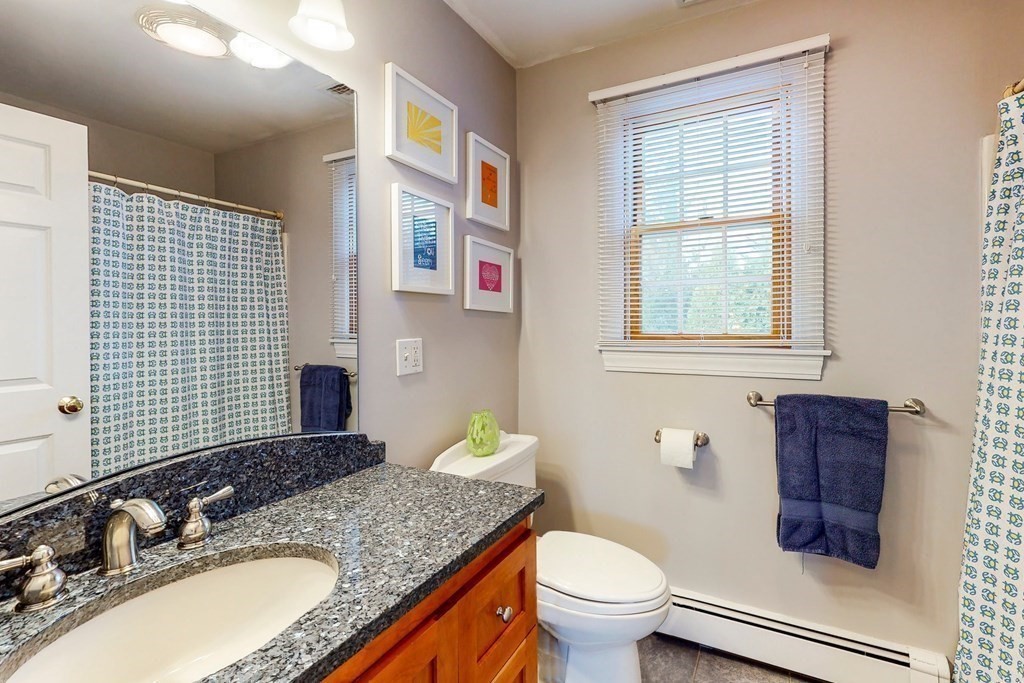9 Mellen Street Needham, MA 02494 - Photo 31 of 42 a bathroom with a granite countertop toilet sink and mirror