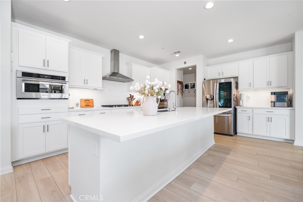 12829 Stags Leap Drive Riverside, CA 92503 - Photo 14 of 54 a large white kitchen with stainless steel appliances cabinets and a sink