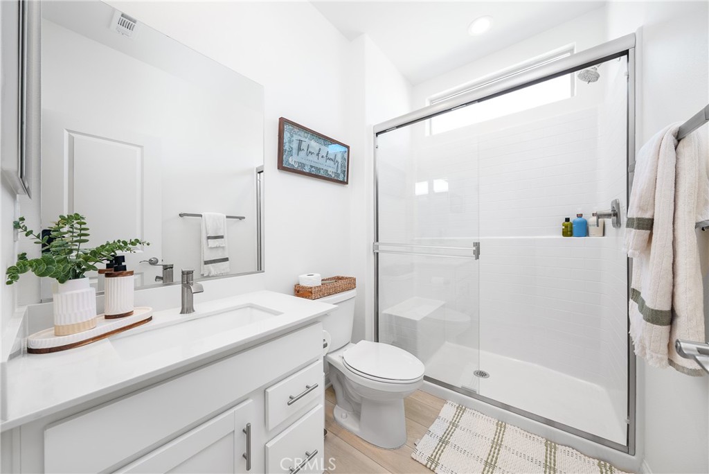 12829 Stags Leap Drive Riverside, CA 92503 - Photo 23 of 54 a bathroom with a sink a toilet and shower