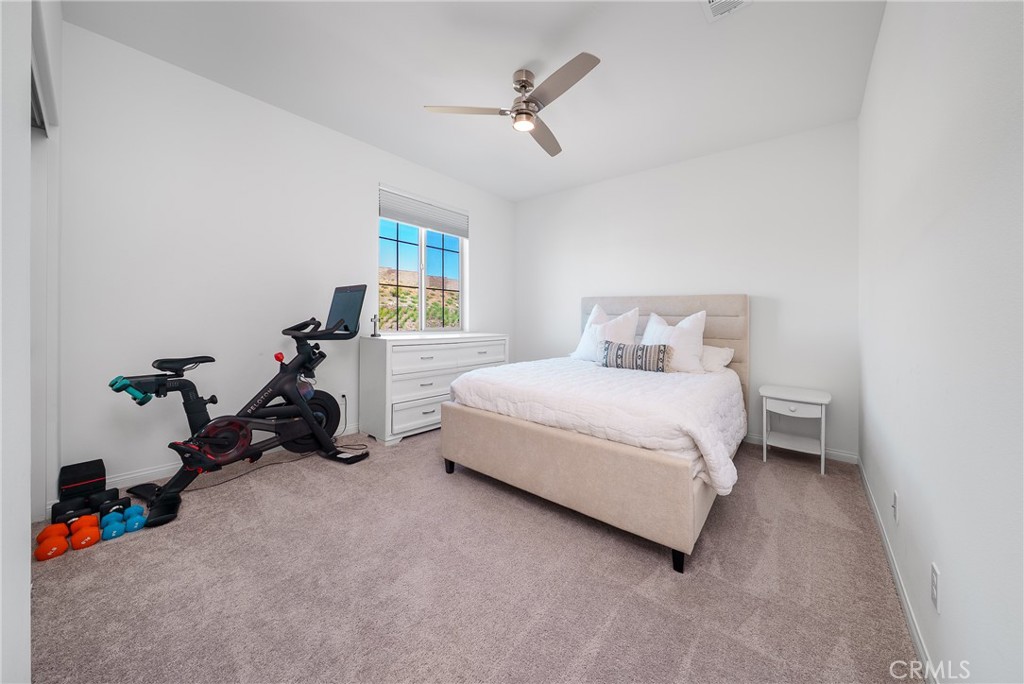 12829 Stags Leap Drive Riverside, CA 92503 - Photo 27 of 54 a bed room with a bed and a ceiling fan
