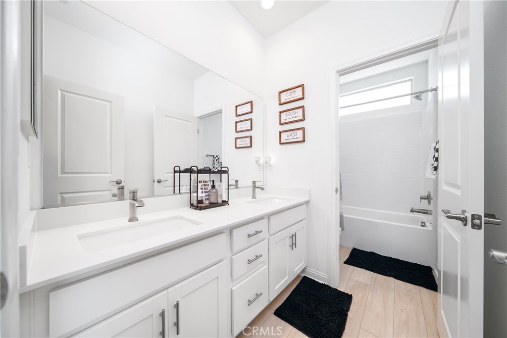 12829 Stags Leap Drive Riverside, CA 92503 - Photo 28 of 54 a spacious bathroom with a double vanity sink a mirror and a bathtub
