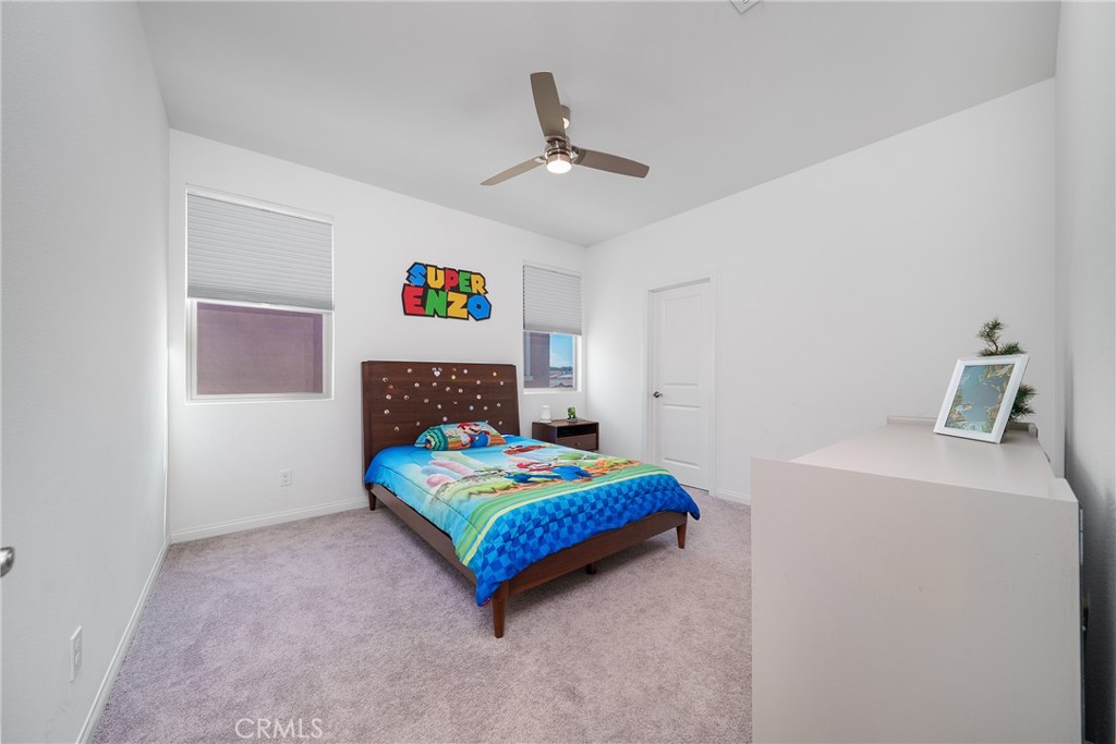 12829 Stags Leap Drive Riverside, CA 92503 - Photo 30 of 54 a bedroom with a bed and a table