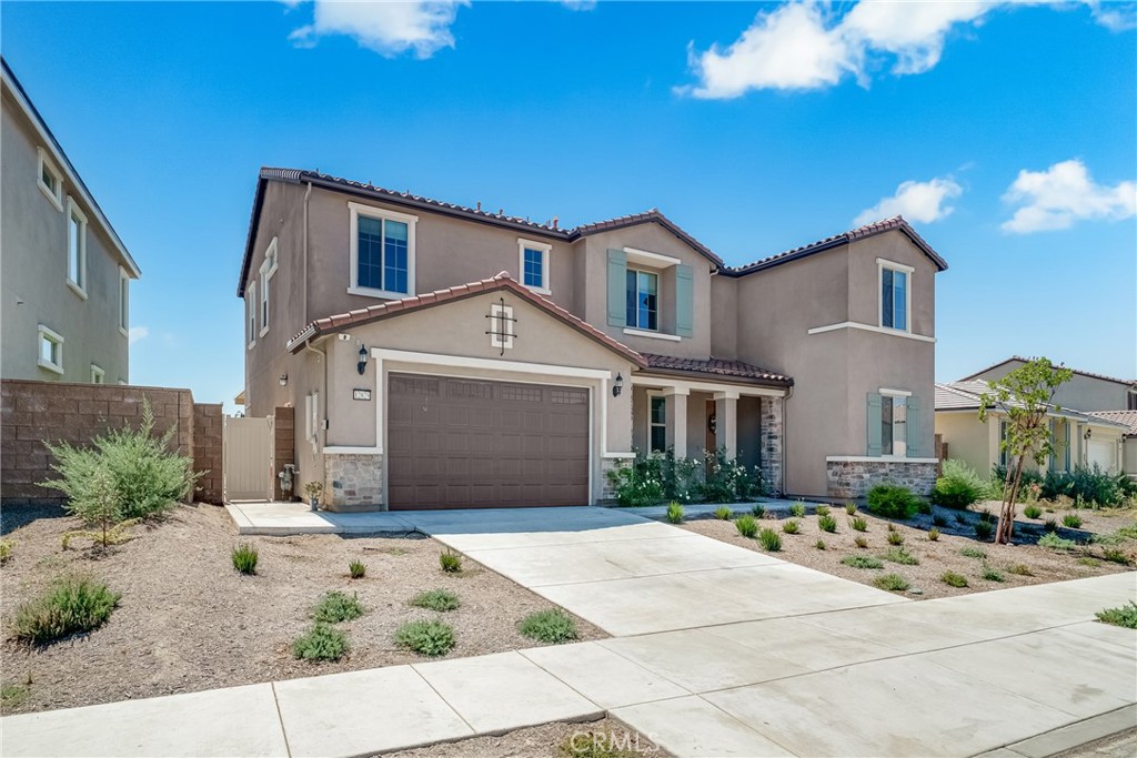 12829 Stags Leap Drive Riverside, CA 92503 - Photo 3 of 54 a front view of a house with a yard and potted plants