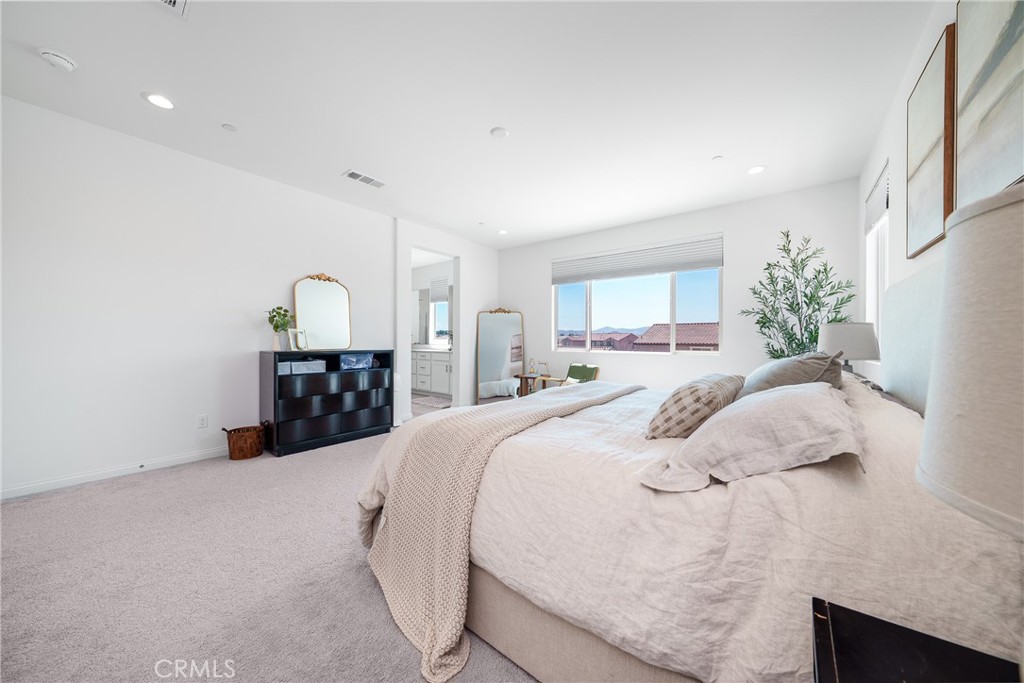 12829 Stags Leap Drive Riverside, CA 92503 - Photo 35 of 54 a bed room with a bed window and a potted plant