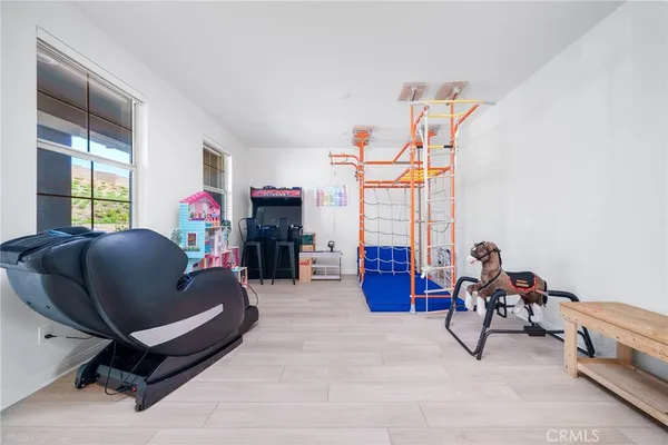 a living room with furniture and a gym machine