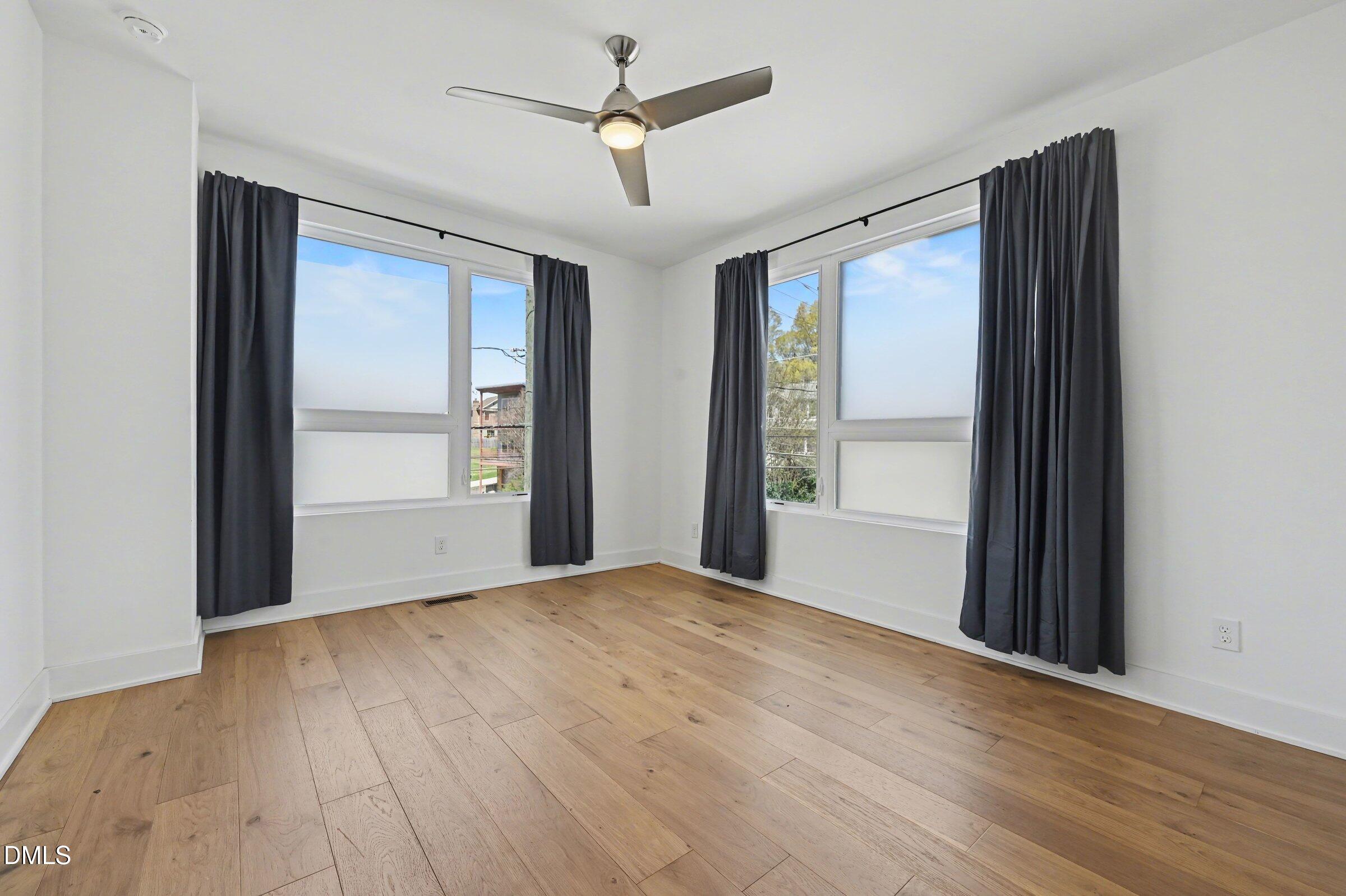 528 North Roxboro Street Durham, NC 27701 - Photo 16 of 26 a view of an empty room with a window and wooden floor