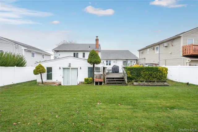 a house view with a sitting space and garden