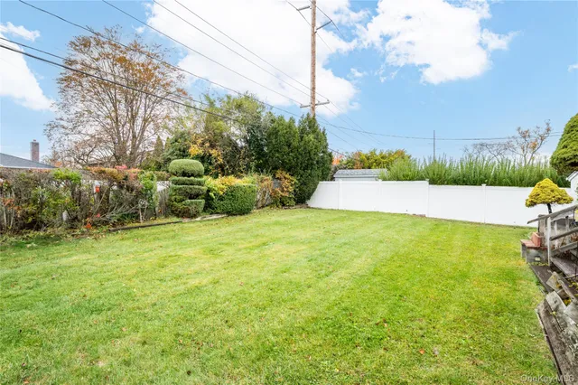 a view of yard with swimming pool and green space