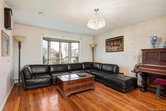 a living room with furniture and a chandelier