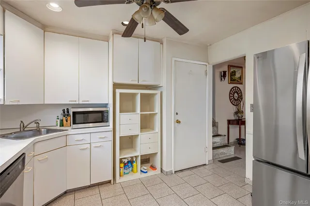 a kitchen with stainless steel appliances a refrigerator sink and cabinets