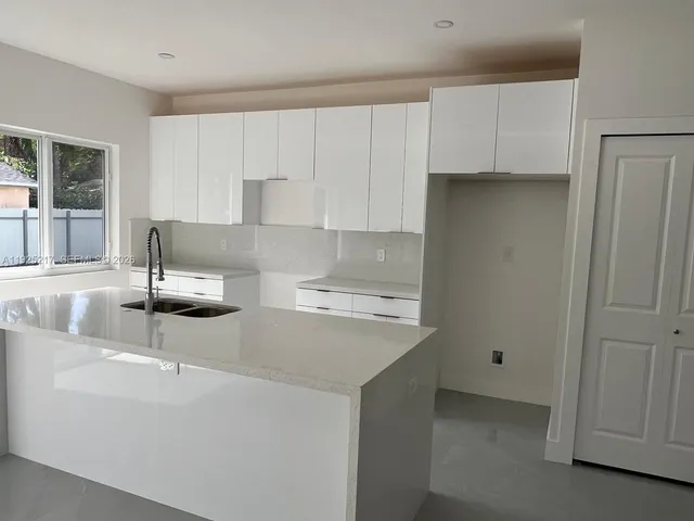 a kitchen with a sink and cabinets