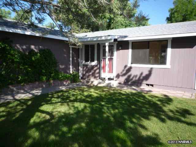 15060 Tourmaline Drive Reno, NV 89521 - Photo 1 of 1 a view of a backyard with table and chairs and potted plants