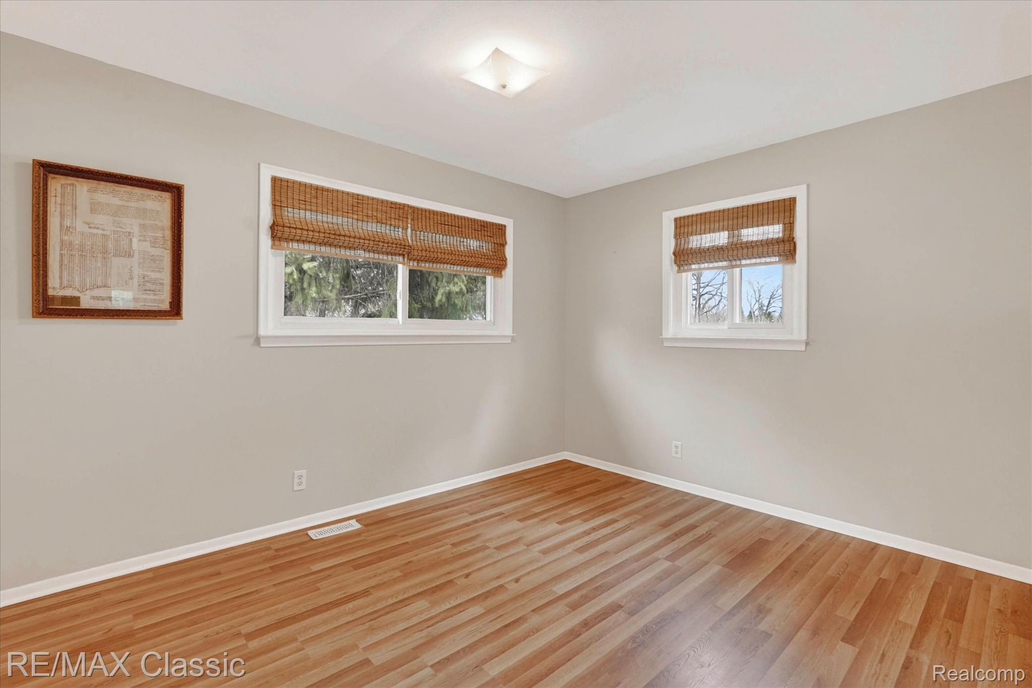 5060 Warmbriar Road White Lake, MI 48383 - Photo 8 of 34 Empty room featuring healthy amount of natural light and light wood-style flooring