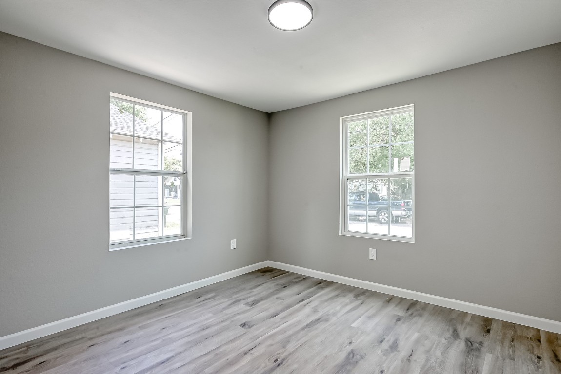 3274 Reeves Street, Unit B Houston, TX 77004 - Photo 4 of 6 a view of an empty room with wooden floor and a window
