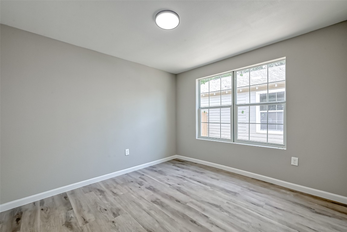 3274 Reeves Street, Unit B Houston, TX 77004 - Photo 5 of 6 an empty room with wooden floor and windows