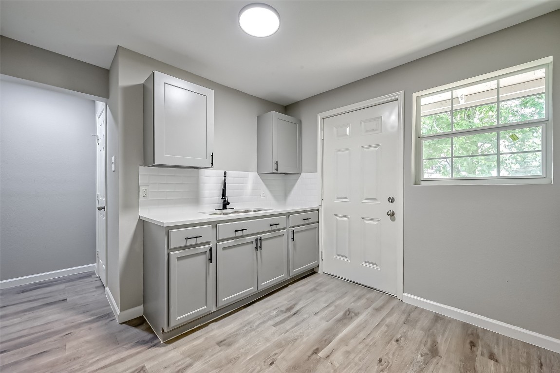 3274 Reeves Street, Unit B Houston, TX 77004 - Photo 6 of 6 a room with a sink cabinets and wooden floor