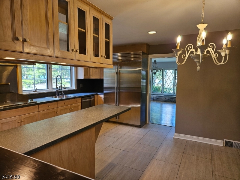 218 Devon Road Essex Fells, NJ 07021 - Photo 13 of 24 a kitchen with stainless steel appliances a refrigerator and a sink