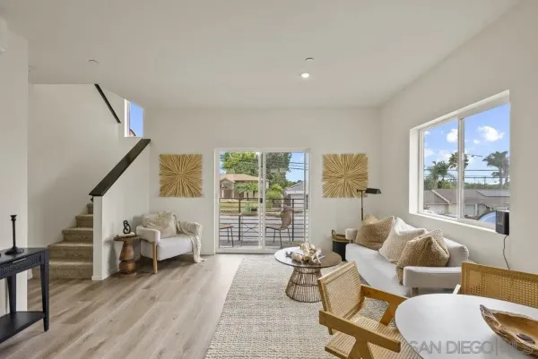 a living room with furniture and a floor to ceiling window