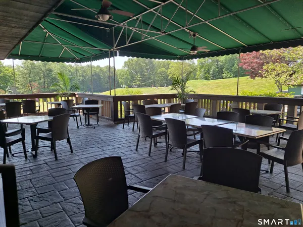 an outdoor space with furniture and umbrella