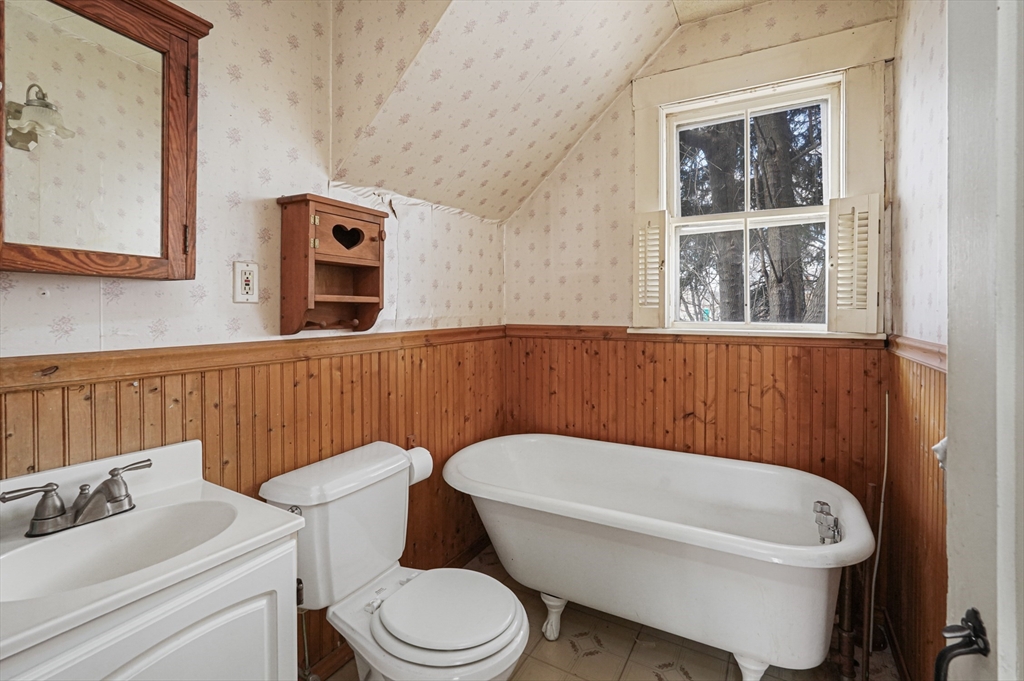 1459 Grafton Road Millbury, MA 01527 - Photo 11 of 42 a white toilet sitting next to a bathroom sink