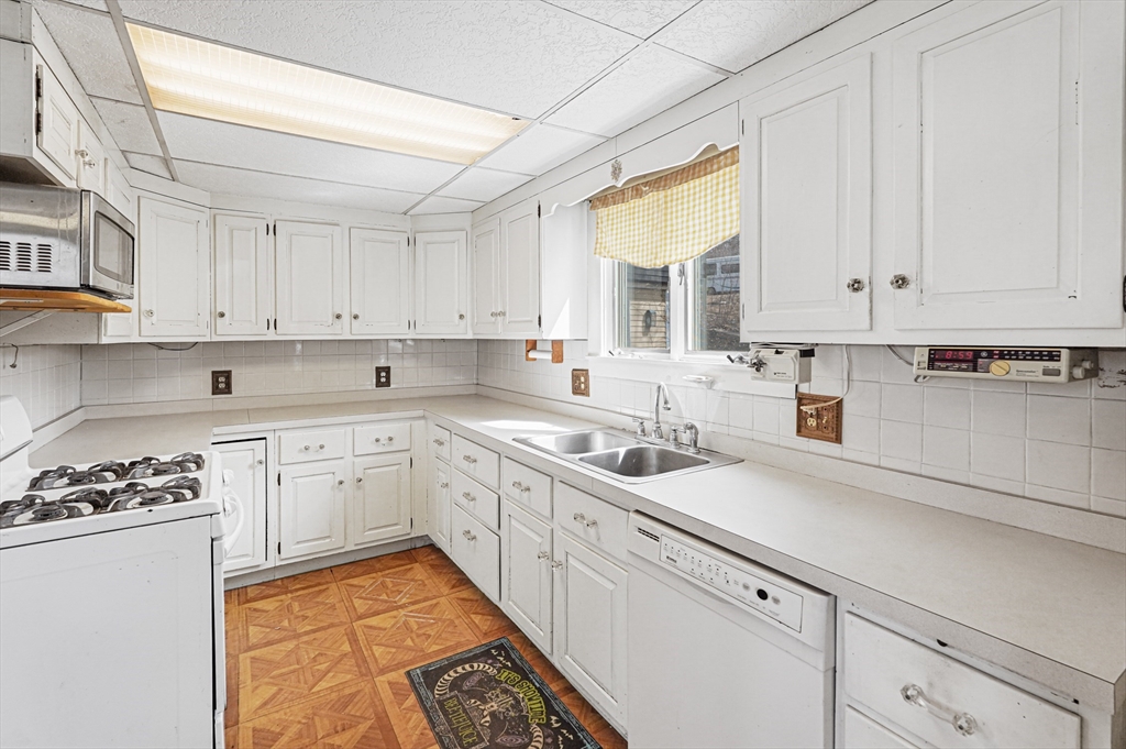 1459 Grafton Road Millbury, MA 01527 - Photo 13 of 42 a kitchen with cabinets appliances a sink and a window