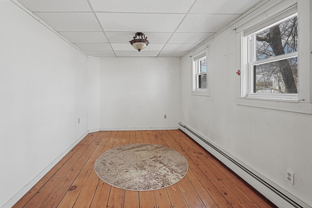 1459 Grafton Road Millbury, MA 01527 - Photo 16 of 42 an empty room with wooden floor and windows