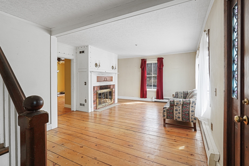 1459 Grafton Road Millbury, MA 01527 - Photo 5 of 42 a view of a hardwood floor and windows in a room