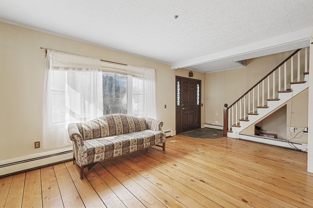 1459 Grafton Road Millbury, MA 01527 - Photo 8 of 42 a living room with furniture and a hard wood floor