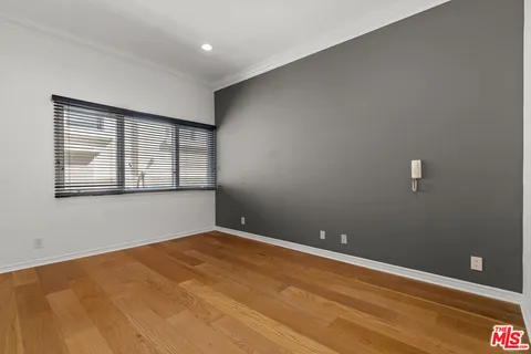 a view of empty room with wooden floor