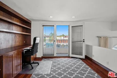 a view of a workspace with furniture and staircase