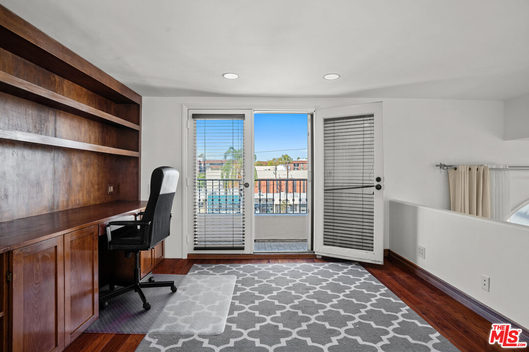 435 Arnaz Drive, Unit 304 Los Angeles, CA 90048 - Photo 20 of 21 a view of a workspace with furniture and staircase